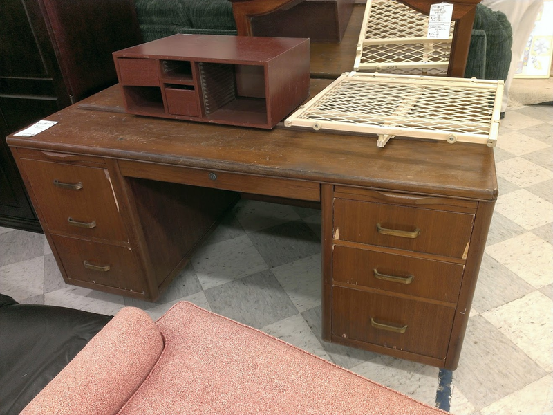 As it sat in the Goodwill store with stuff piled on and around it.